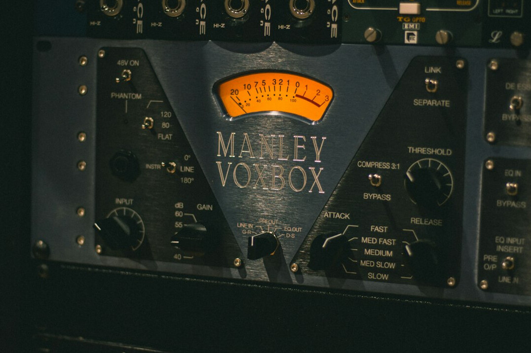 Vintage radio studio microphone in front of a mixing console