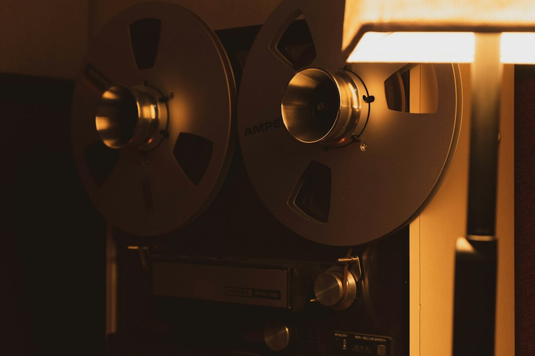 Vintage film editing suite with reel-to-reel tape and monitors