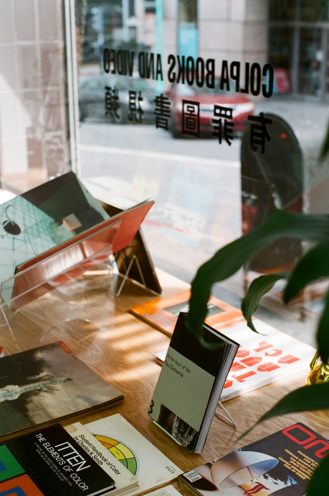 Stack of vintage printed advertising posters on a light table
