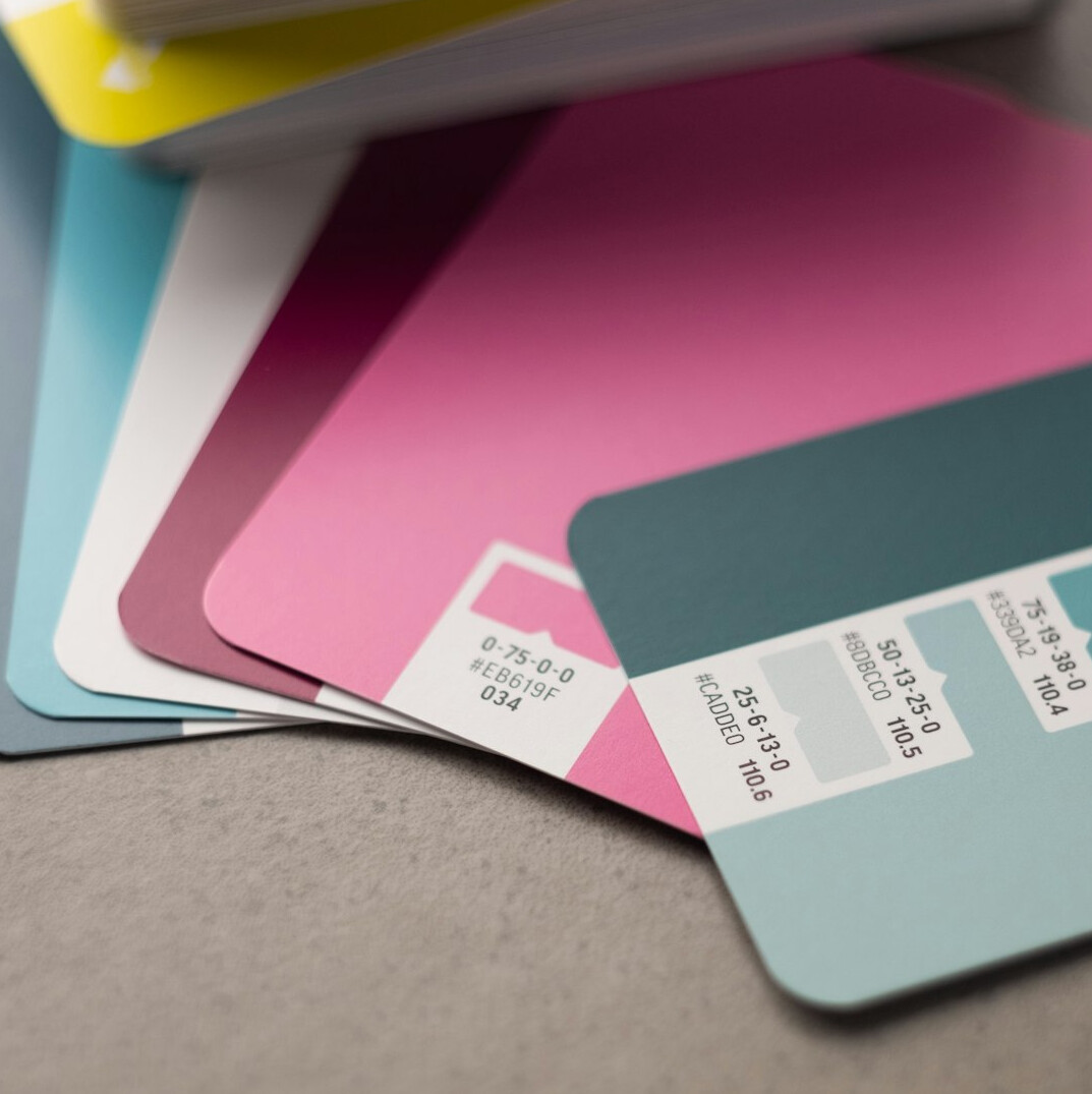 Graphic designer's desk with pantone swatches, rulers and sketches